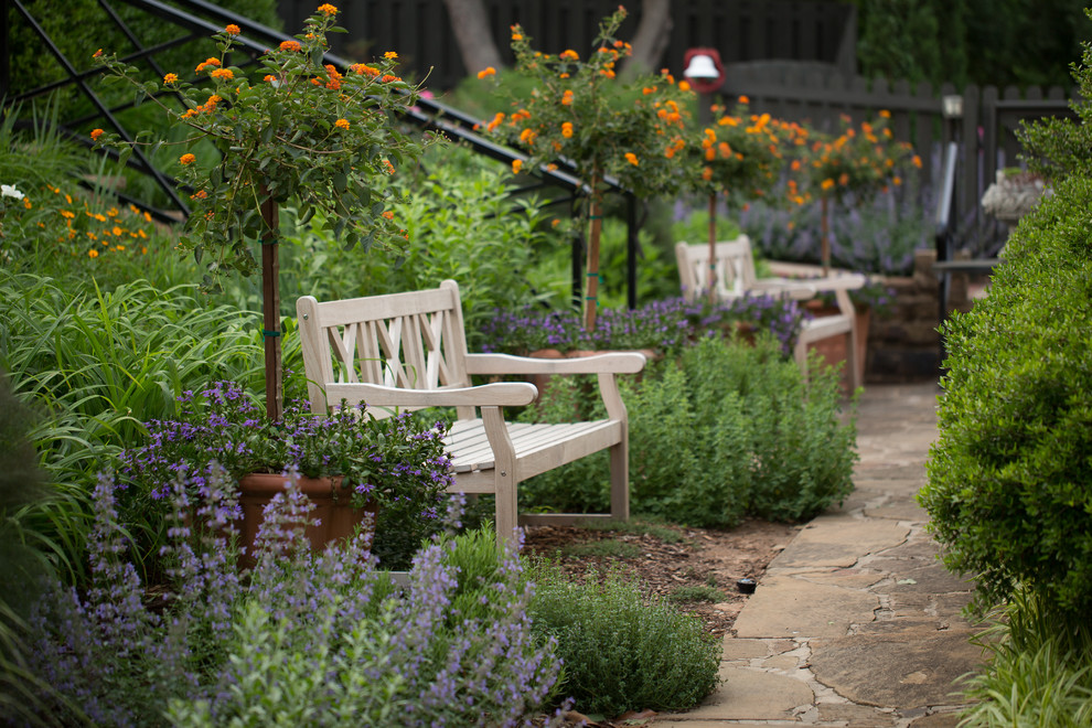 Photo of a traditional backyard garden for fall in Little Rock with natural stone pavers.