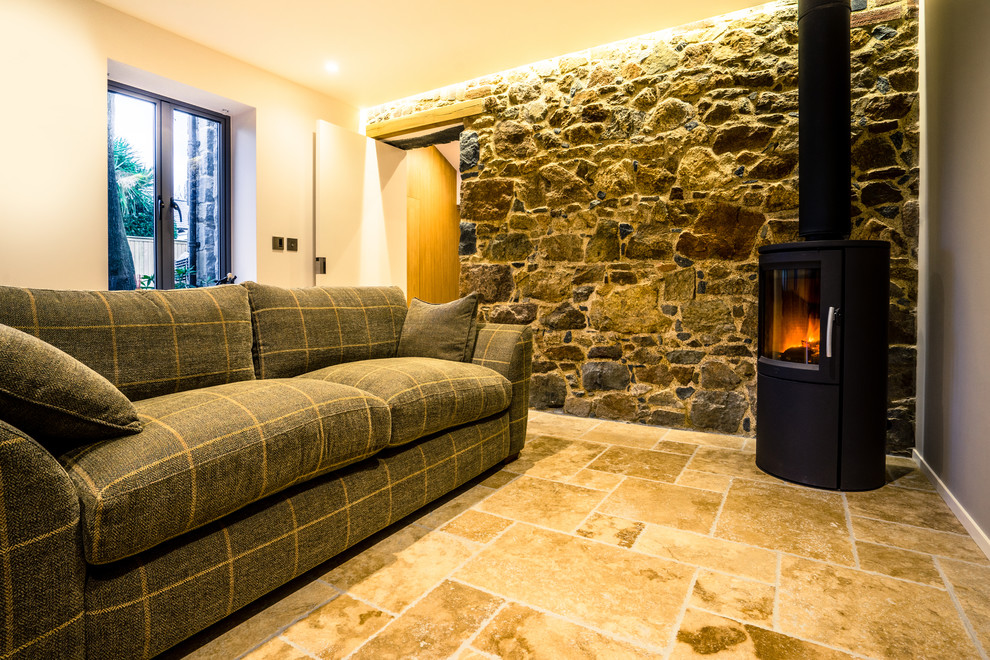 Design ideas for a rustic open plan living room in Channel Islands with white walls, ceramic flooring and a wood burning stove.