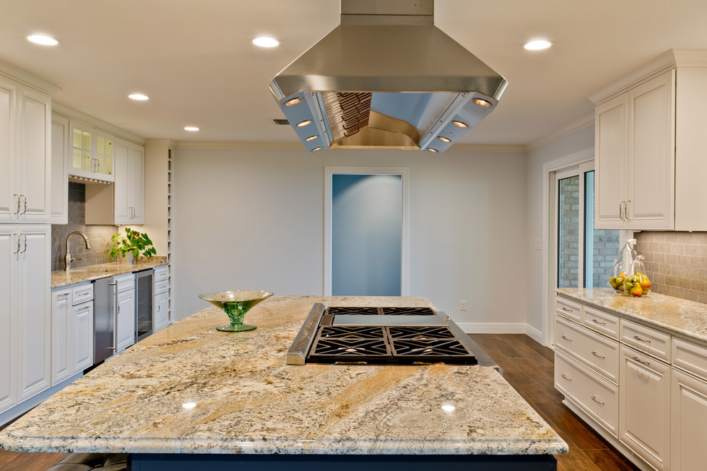 Large transitional galley porcelain tile eat-in kitchen photo in Miami with an undermount sink, raised-panel cabinets, white cabinets, granite countertops, gray backsplash, porcelain backsplash, stainless steel appliances and an island