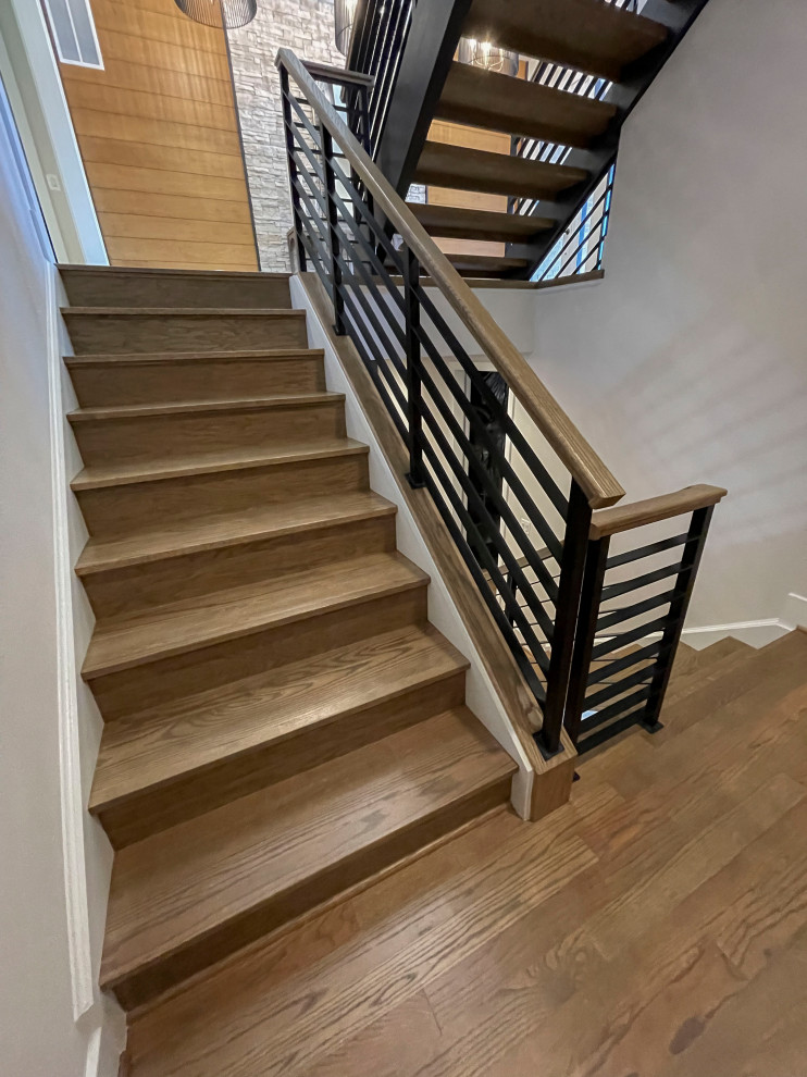 Inspiration for a large contemporary wood straight staircase in DC Metro with mixed railing and panelled walls.