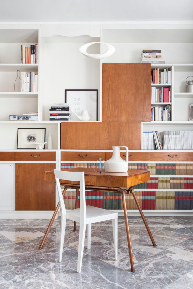 Small midcentury home studio in Milan with white walls, a freestanding desk and marble floors.