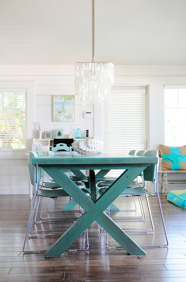 Beach style dining room in Tampa with white walls and dark hardwood floors.