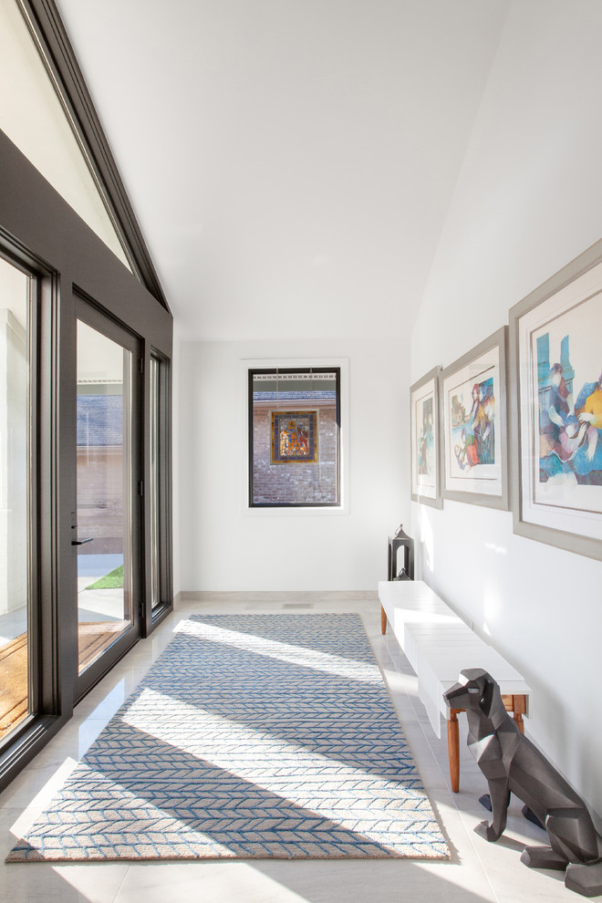 Mid-sized contemporary vestibule in Indianapolis with white walls, porcelain floors, a single front door, grey floor and a glass front door.