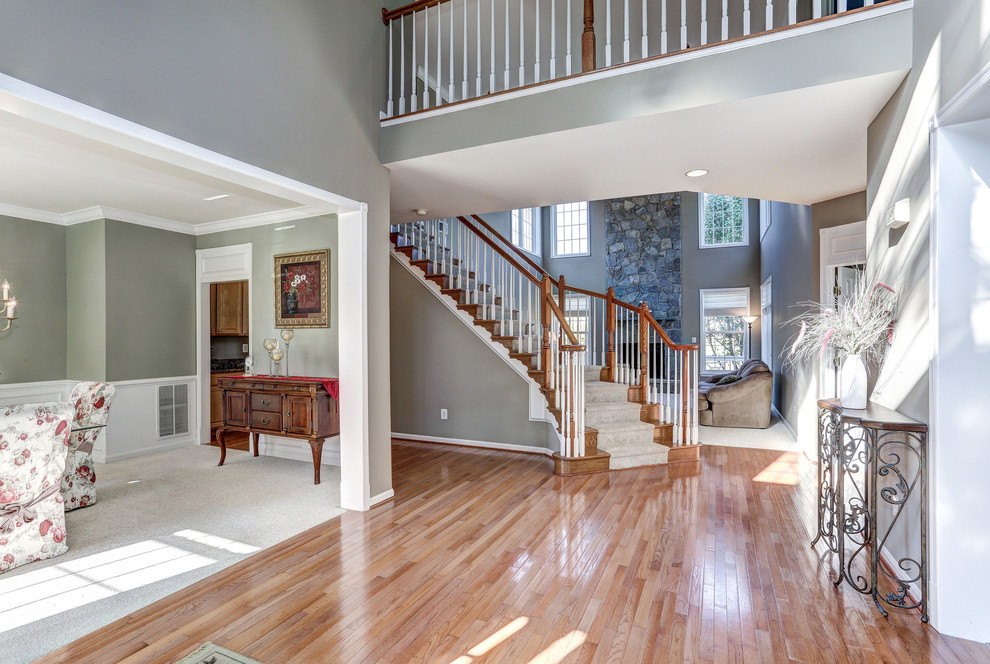 Inspiration for a huge transitional medium tone wood floor foyer remodel in DC Metro with gray walls