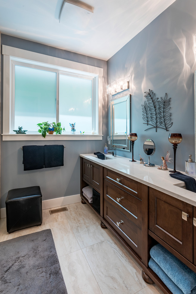 This is an example of a large traditional master bathroom in Vancouver with shaker cabinets, medium wood cabinets, a two-piece toilet, grey walls, ceramic floors, an undermount sink, granite benchtops, white floor, white benchtops, a corner shower, a hinged shower door and ceramic tile.