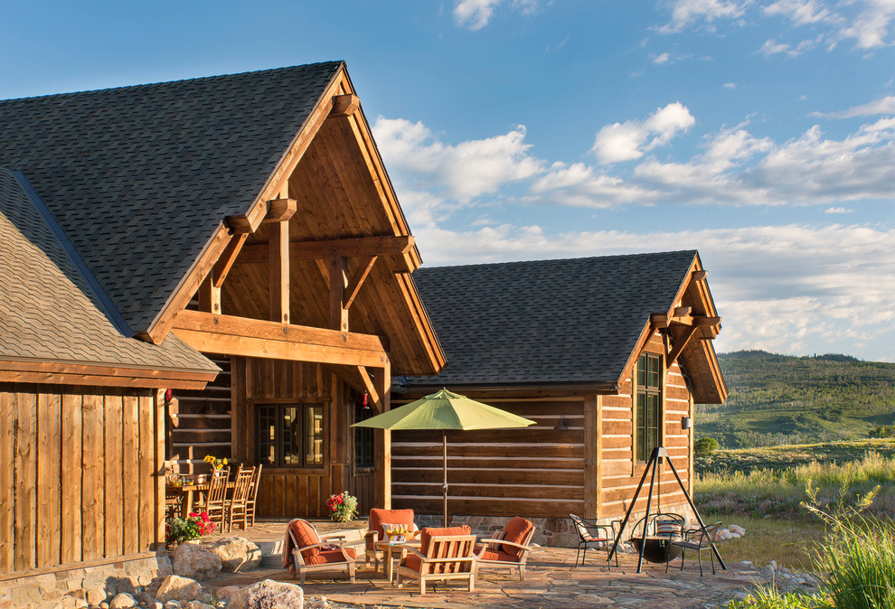 Inspiration for a rustic backyard patio remodel with decking and a roof extension