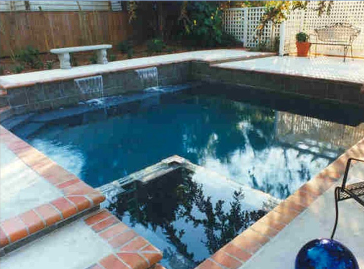 Small transitional backyard pool fountain photo in Miami
