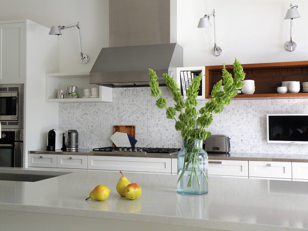 Inspiration for a large transitional galley dark wood floor open concept kitchen remodel in Ottawa with an undermount sink, shaker cabinets, white cabinets, quartzite countertops, mosaic tile backsplash, stainless steel appliances and an island