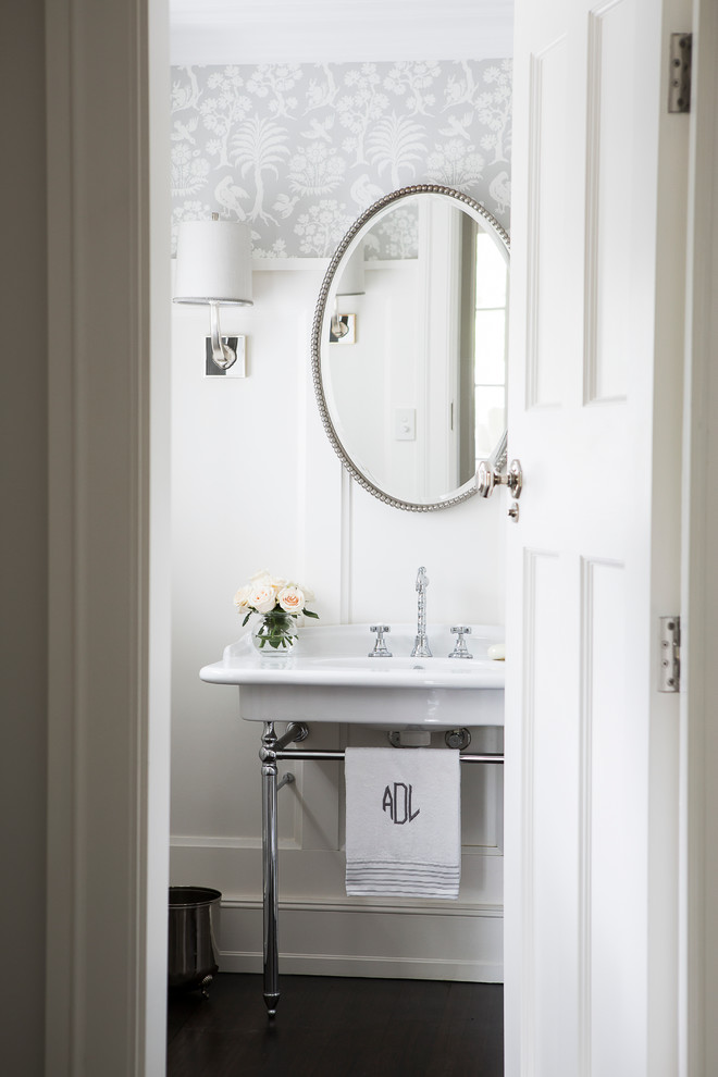 This is an example of a traditional powder room in Sydney with dark hardwood floors and a pedestal sink.