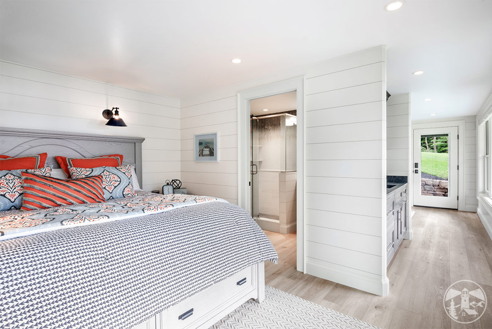 Inspiration for a small beach style guest bedroom in Boston with white walls, vinyl floors, no fireplace, beige floor and planked wall panelling.