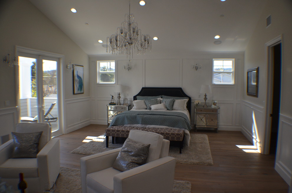Design ideas for a mid-sized transitional master bedroom in Los Angeles with beige walls, light hardwood floors, brown floor, a brick fireplace surround and a standard fireplace.