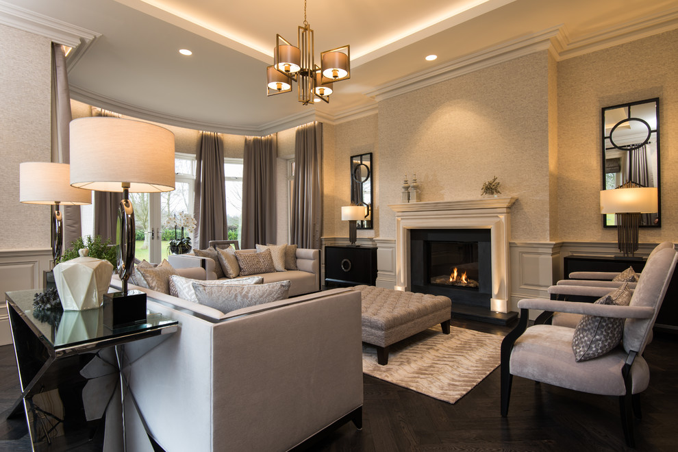 Design ideas for an expansive traditional formal enclosed living room in Belfast with beige walls, dark hardwood floors, a standard fireplace, a stone fireplace surround and brown floor.