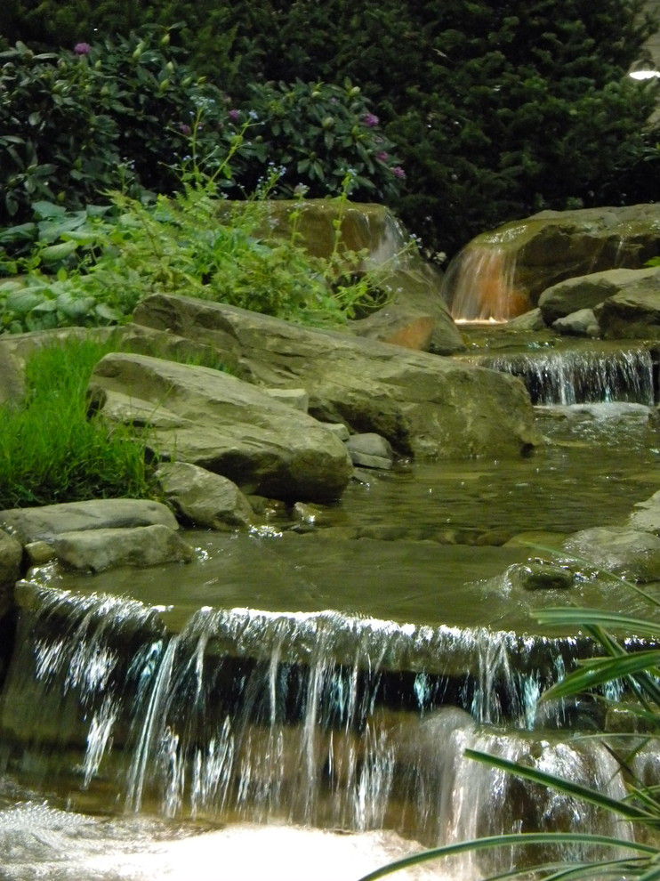This is an example of a traditional garden in Cleveland with with pond.
