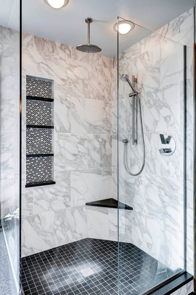This is an example of an expansive transitional master bathroom in Denver with a vessel sink, flat-panel cabinets, medium wood cabinets, engineered quartz benchtops, a drop-in tub, a corner shower, a two-piece toilet, black tile, stone tile, white walls and porcelain floors.