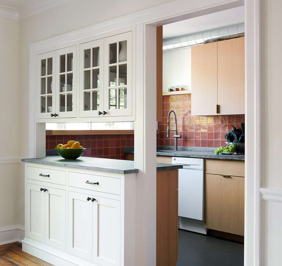 Design ideas for a small contemporary galley enclosed kitchen in Philadelphia with a submerged sink, flat-panel cabinets, light wood cabinets, soapstone worktops, orange splashback, ceramic splashback, stainless steel appliances, lino flooring, a breakfast bar, grey floors and grey worktops.