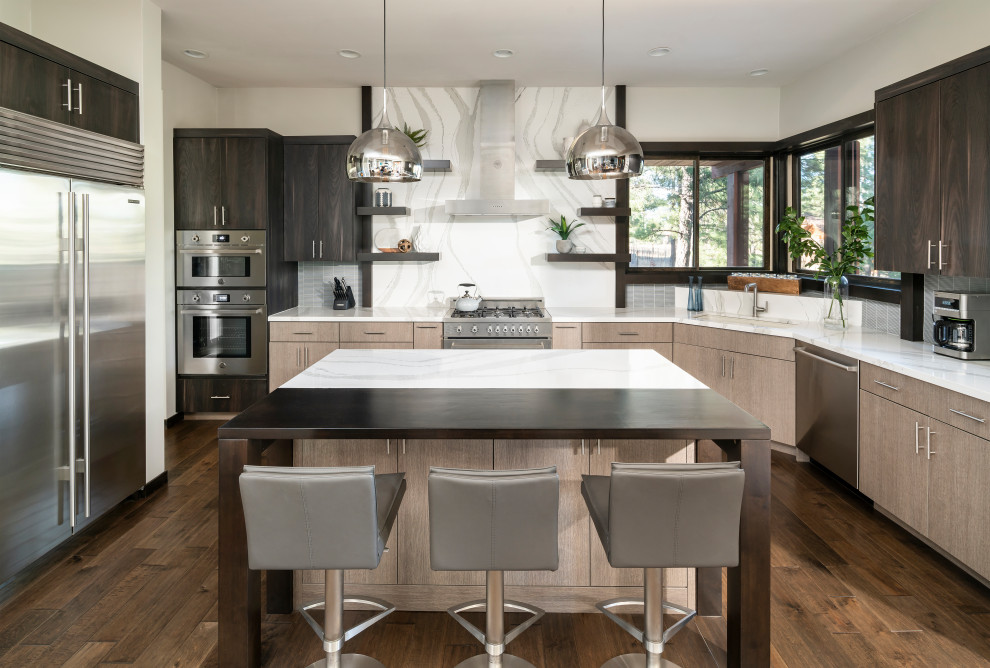 Inspiration for a contemporary kitchen in Phoenix with an undermount sink, flat-panel cabinets, dark wood cabinets, white splashback, stone slab splashback, stainless steel appliances, dark hardwood floors, with island, brown floor and white benchtop.