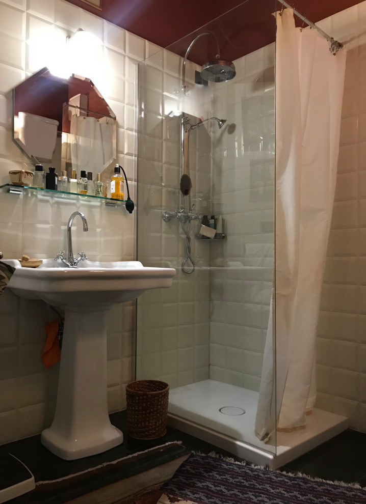 Small classic bathroom with a corner shower, metro tiles, a pedestal sink, a shower curtain, a single sink, a two-piece toilet, white tiles, white walls, marble flooring, black floors and exposed beams.