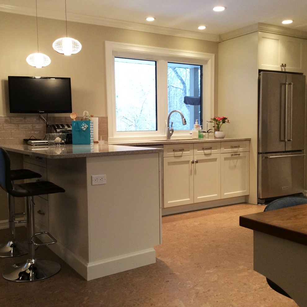 Transitional cork floor kitchen photo in Edmonton with white cabinets, quartzite countertops, gray backsplash, ceramic backsplash and stainless steel appliances