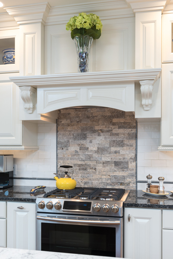 Inspiration for a large transitional single-wall light wood floor and brown floor open concept kitchen remodel with a farmhouse sink, raised-panel cabinets, white cabinets, quartz countertops, white backsplash, ceramic backsplash, stainless steel appliances, an island and white countertops