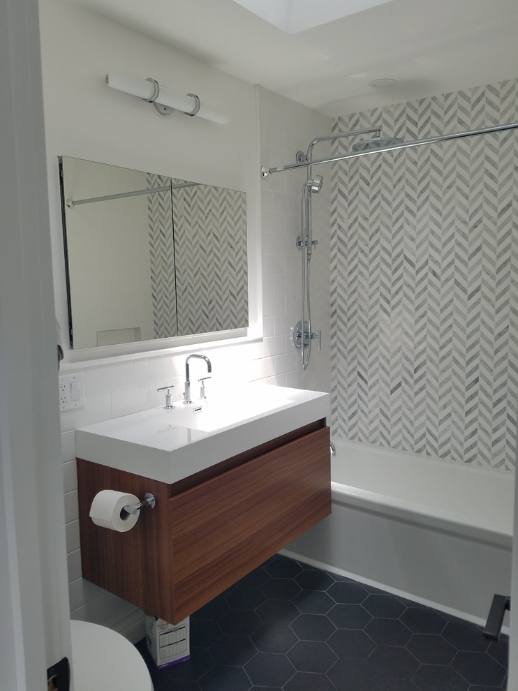 Large modern 3/4 bathroom in New York with flat-panel cabinets, brown cabinets, a corner tub, a shower/bathtub combo, white walls, porcelain floors, a trough sink and grey floor.