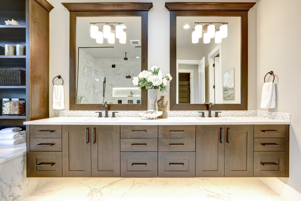Large transitional master bathroom in DC Metro with shaker cabinets, white tile, porcelain floors, an undermount sink, engineered quartz benchtops, white floor, white benchtops, dark wood cabinets, subway tile and beige walls.