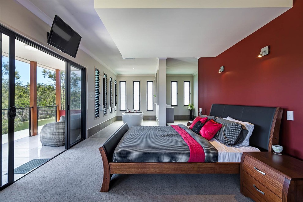 This is an example of an asian master bedroom in Brisbane with red walls and carpet.