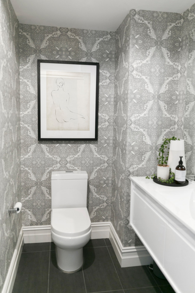Design ideas for a small contemporary powder room in Sydney with white cabinets, ceramic floors and black floor.