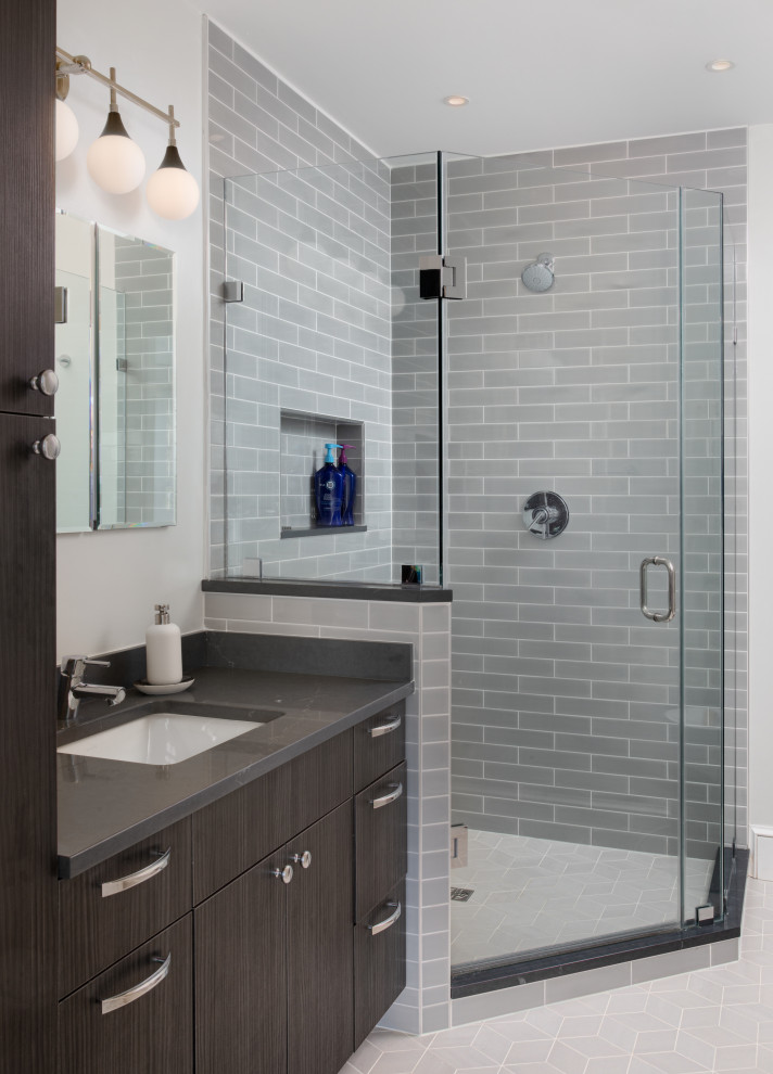 Photo of a medium sized traditional grey and brown ensuite bathroom in DC Metro with brown cabinets, a corner shower, a bidet, grey tiles, grey walls, porcelain flooring, a submerged sink, beige floors, a hinged door, grey worktops, a single sink, flat-panel cabinets, porcelain tiles, a wall niche, a built in vanity unit and engineered stone worktops.