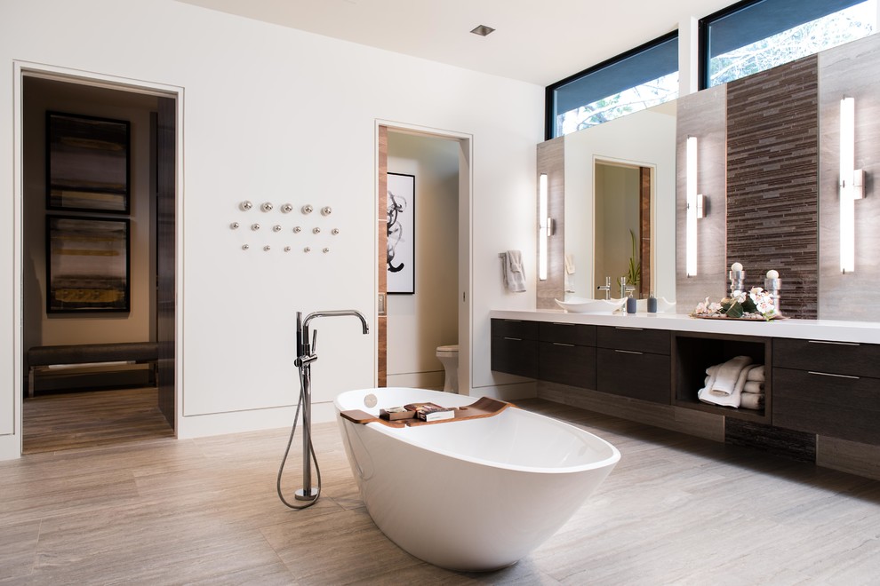 Design ideas for a large modern master bathroom in Las Vegas with flat-panel cabinets, dark wood cabinets, a freestanding tub, white walls, a vessel sink, grey floor, white benchtops, brown tile, matchstick tile, porcelain floors, engineered quartz benchtops and an enclosed toilet.