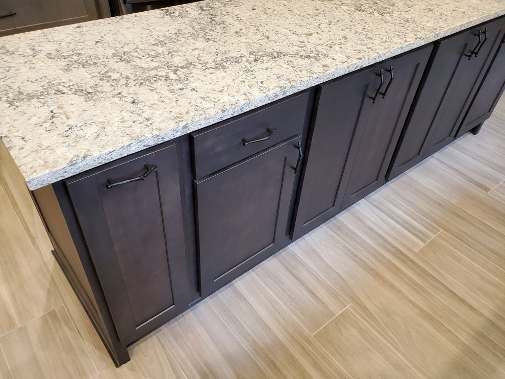 Mid-sized transitional porcelain tile and gray floor kitchen photo with shaker cabinets, gray cabinets, quartz countertops, stainless steel appliances, an island and white countertops