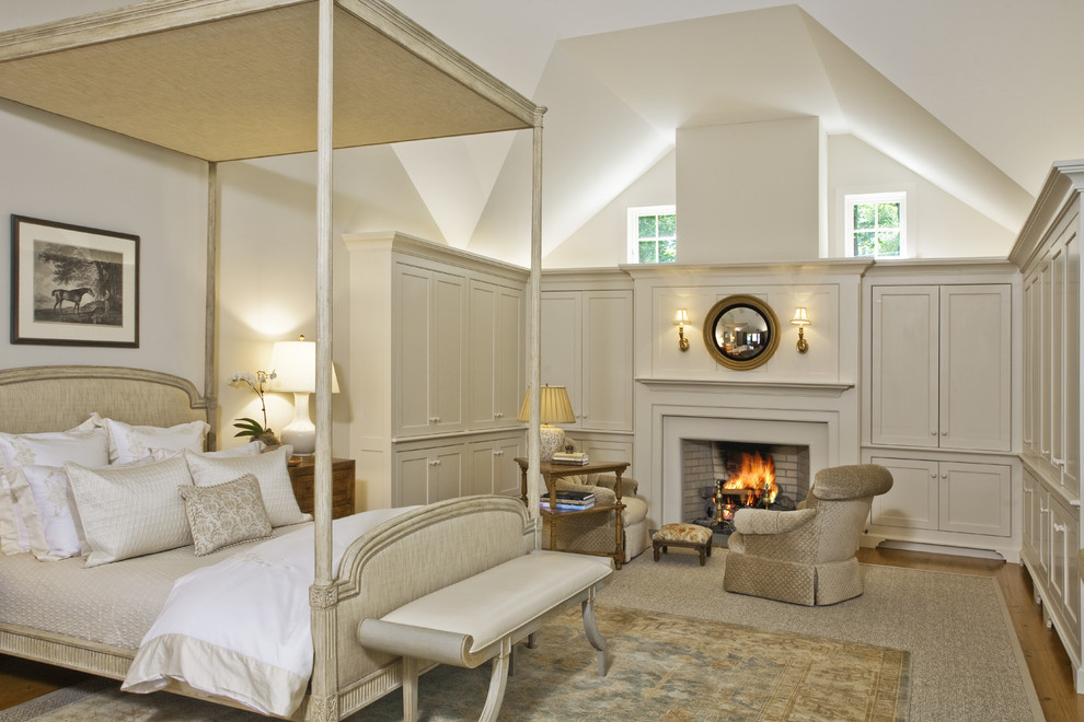 Inspiration for a traditional bedroom in Philadelphia with beige walls, medium hardwood floors and a standard fireplace.