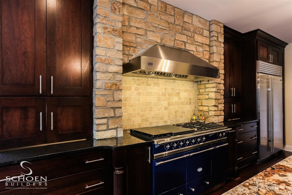 Eat-in kitchen - large transitional u-shaped dark wood floor eat-in kitchen idea with an undermount sink, recessed-panel cabinets, dark wood cabinets, granite countertops, beige backsplash, subway tile backsplash, colored appliances and two islands