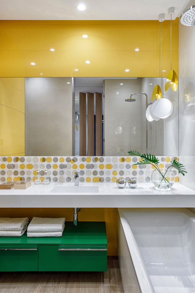 Design ideas for a mid-sized scandinavian master bathroom in Moscow with flat-panel cabinets, green cabinets, an undermount tub, a shower/bathtub combo, a wall-mount toilet, yellow tile, ceramic tile, yellow walls, porcelain floors, an undermount sink, solid surface benchtops, beige floor, an open shower, white benchtops, a niche, a single vanity and a floating vanity.