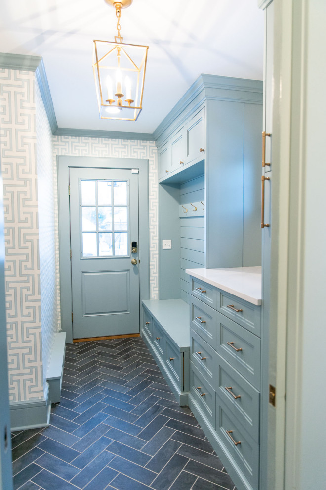 Design ideas for a mid-sized transitional mudroom in New York with blue walls, ceramic floors, a single front door, a blue front door, grey floor and wallpaper.