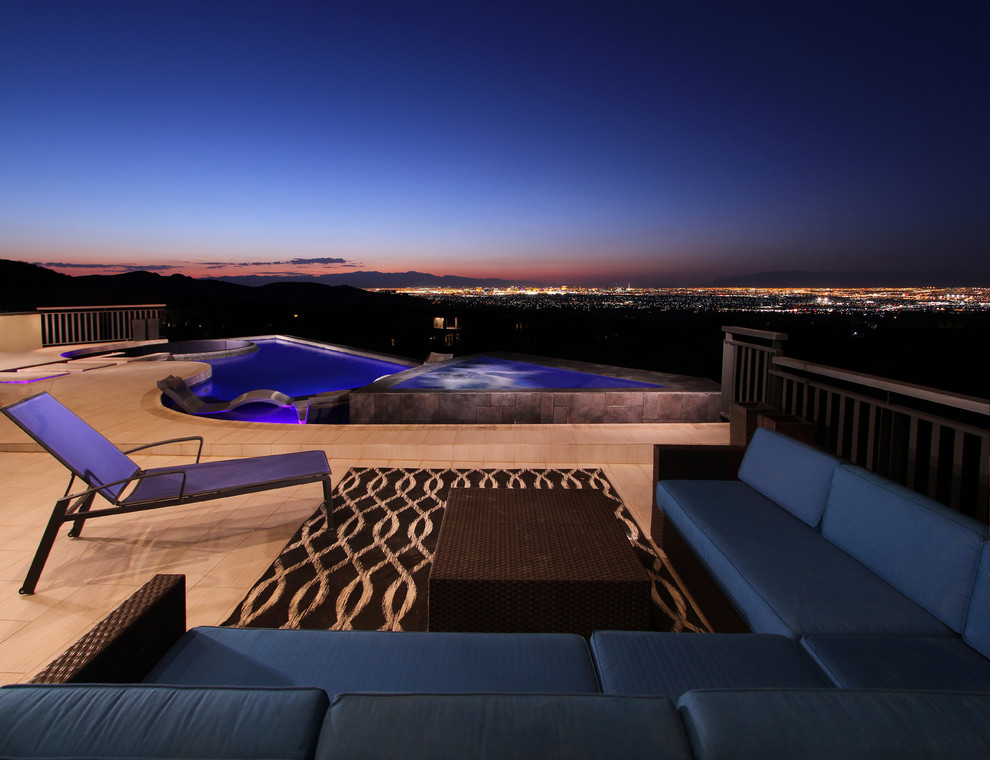 Inspiration for a mid-sized modern rooftop custom-shaped infinity pool in Las Vegas with a water feature.