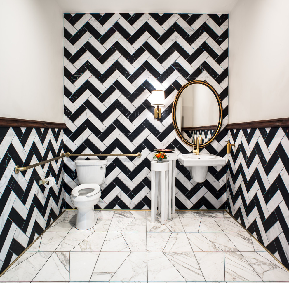 Mid-sized eclectic powder room in San Francisco with stone tile, marble floors, a wall-mount sink, a two-piece toilet and black and white tile.
