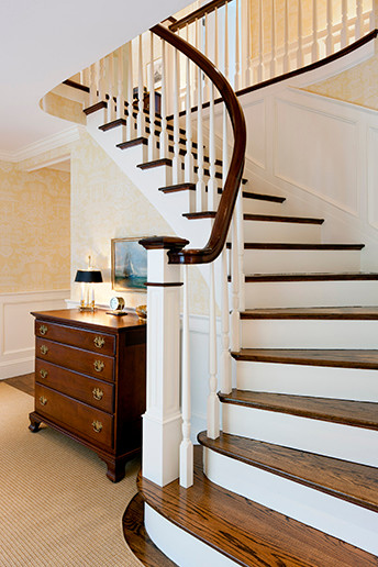Inspiration for a mid-sized traditional wood curved staircase in Boston with wood risers.