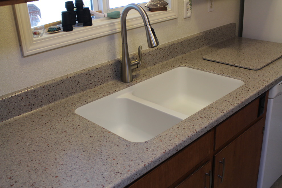 Inspiration for a contemporary kitchen remodel with an integrated sink and solid surface countertops