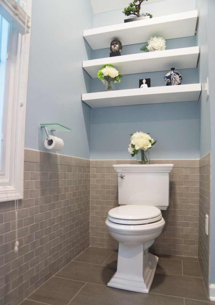 Large transitional master bathroom in Chicago with recessed-panel cabinets, white cabinets, a freestanding tub, a double shower, a one-piece toilet, blue tile, ceramic tile, blue walls, ceramic floors, a drop-in sink, marble benchtops, brown floor, a hinged shower door and white benchtops.