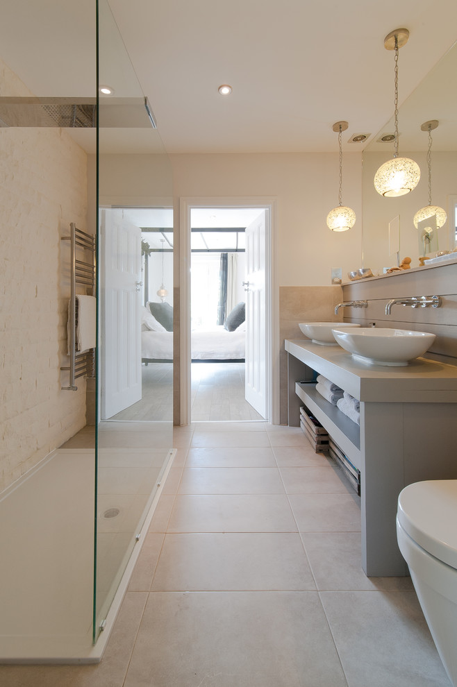 This is an example of a transitional bathroom in Surrey with a vessel sink, open cabinets, an open shower, white tile, stone tile, beige walls and an open shower.
