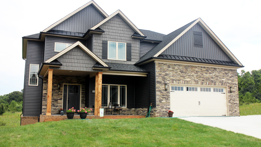 This is an example of a mid-sized traditional two-storey grey exterior in Other with vinyl siding.