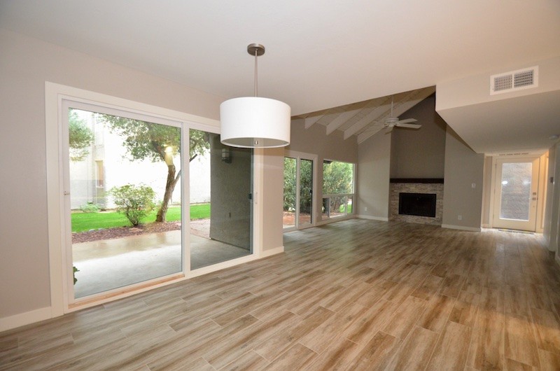 Design ideas for a mid-sized midcentury open concept living room in Phoenix with beige walls, light hardwood floors and beige floor.