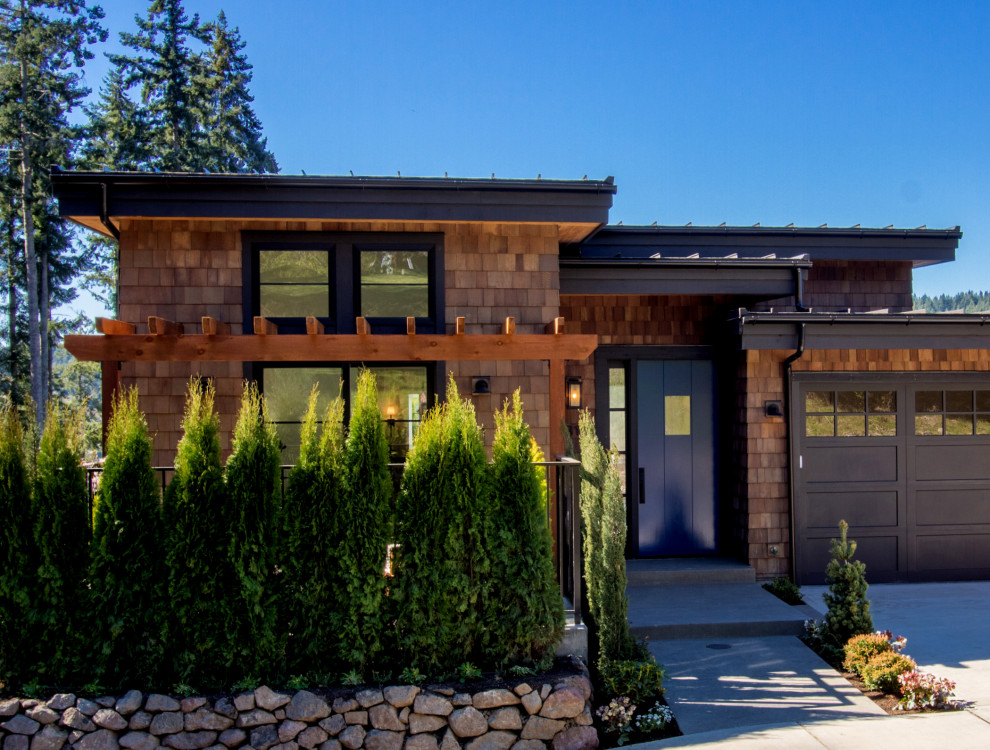 This is an example of a mid-sized transitional two-storey brown townhouse exterior in Seattle with wood siding, a shed roof and a metal roof.