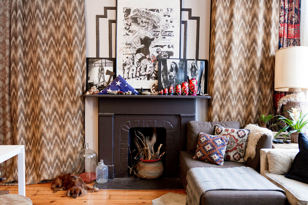 Design ideas for an eclectic family room in New York with beige walls and a standard fireplace.
