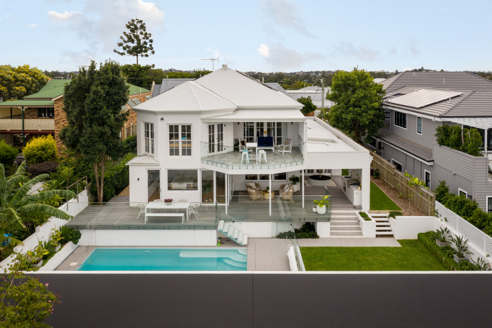 Inspiration for a large white two-story brick house exterior remodel in Brisbane with a hip roof, a metal roof and a white roof