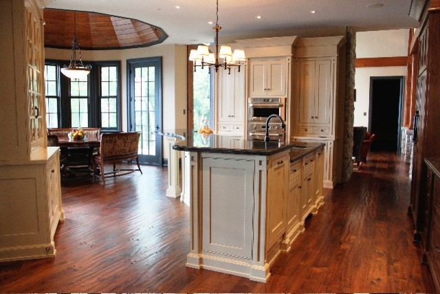 Example of a dark wood floor kitchen design with an island