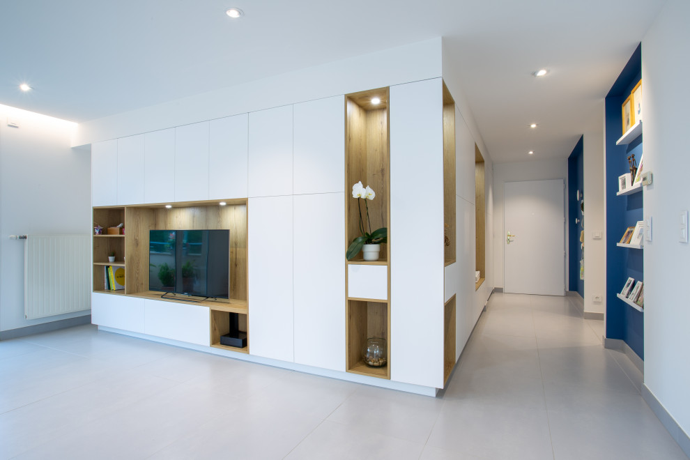 This is an example of a large contemporary foyer in Lyon with blue walls, ceramic floors, a single front door, a white front door, grey floor and coffered.