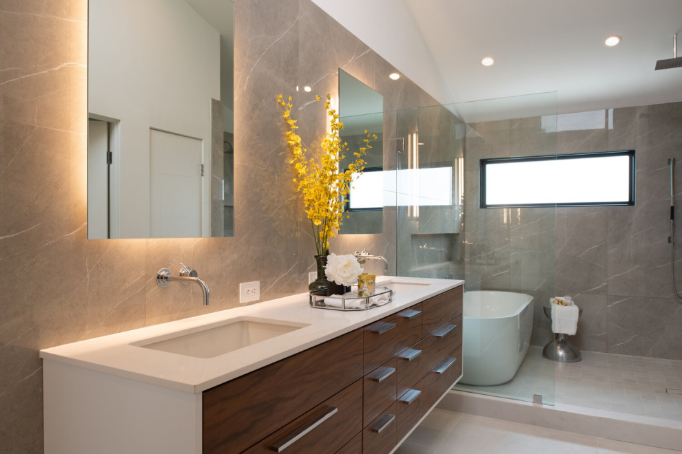 Large contemporary master wet room bathroom in San Diego with flat-panel cabinets, medium wood cabinets, a one-piece toilet, porcelain tile, white walls, a wall-mount sink, a floating vanity, a freestanding tub, porcelain floors, engineered quartz benchtops, white benchtops and a double vanity.