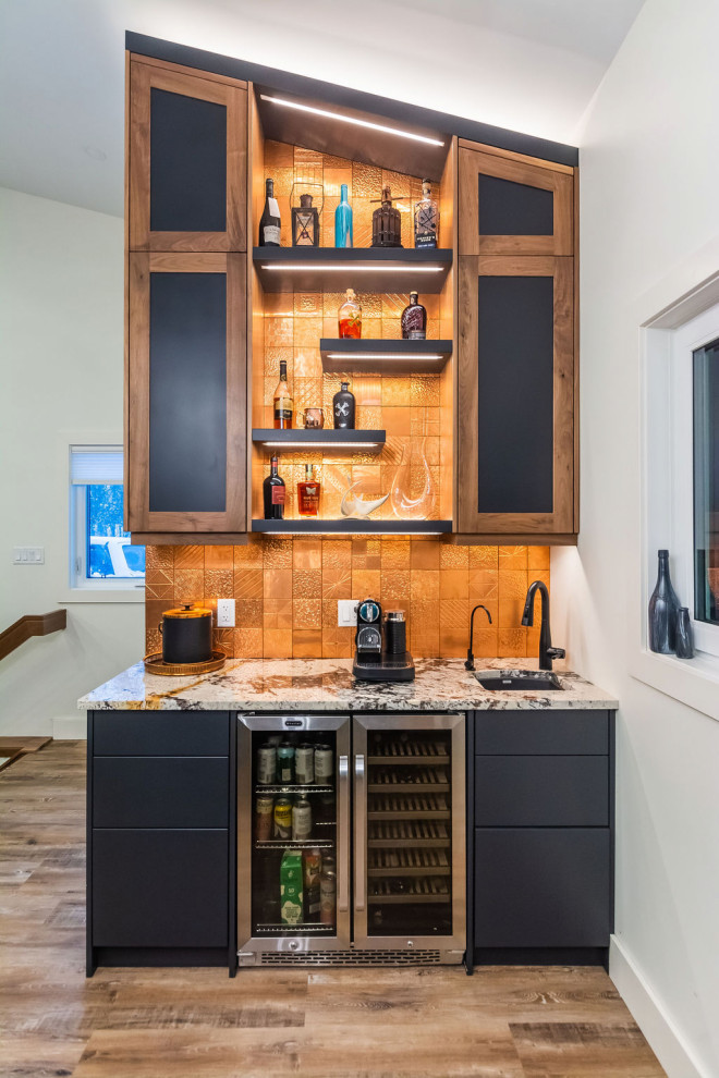 Design ideas for a small contemporary single-wall wet bar in Edmonton with an undermount sink, flat-panel cabinets, black cabinets, granite benchtops, orange splashback, metal splashback, vinyl floors, brown floor and multi-coloured benchtop.