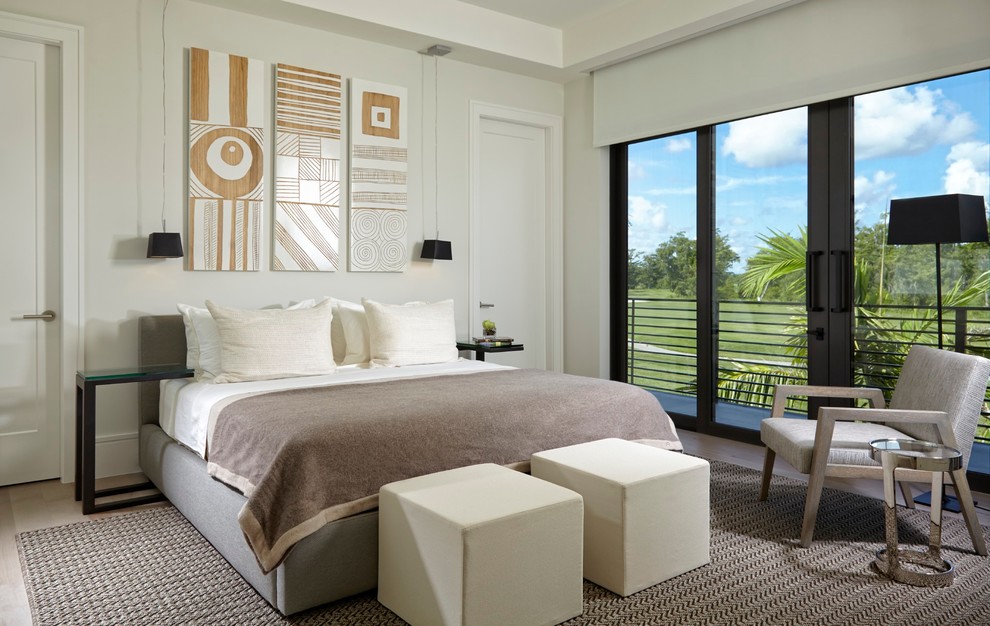 This is an example of a contemporary master bedroom in Miami with white walls.